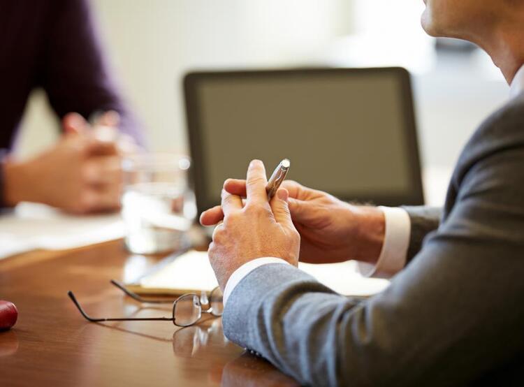 Financial Avisors hands on a conference table